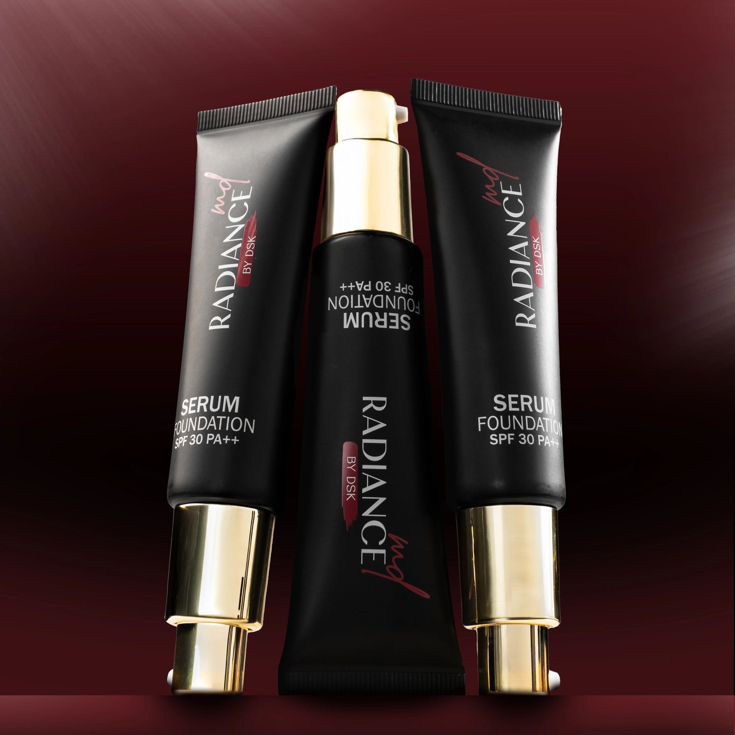 Radiance serum foundation tubes on a dark red background