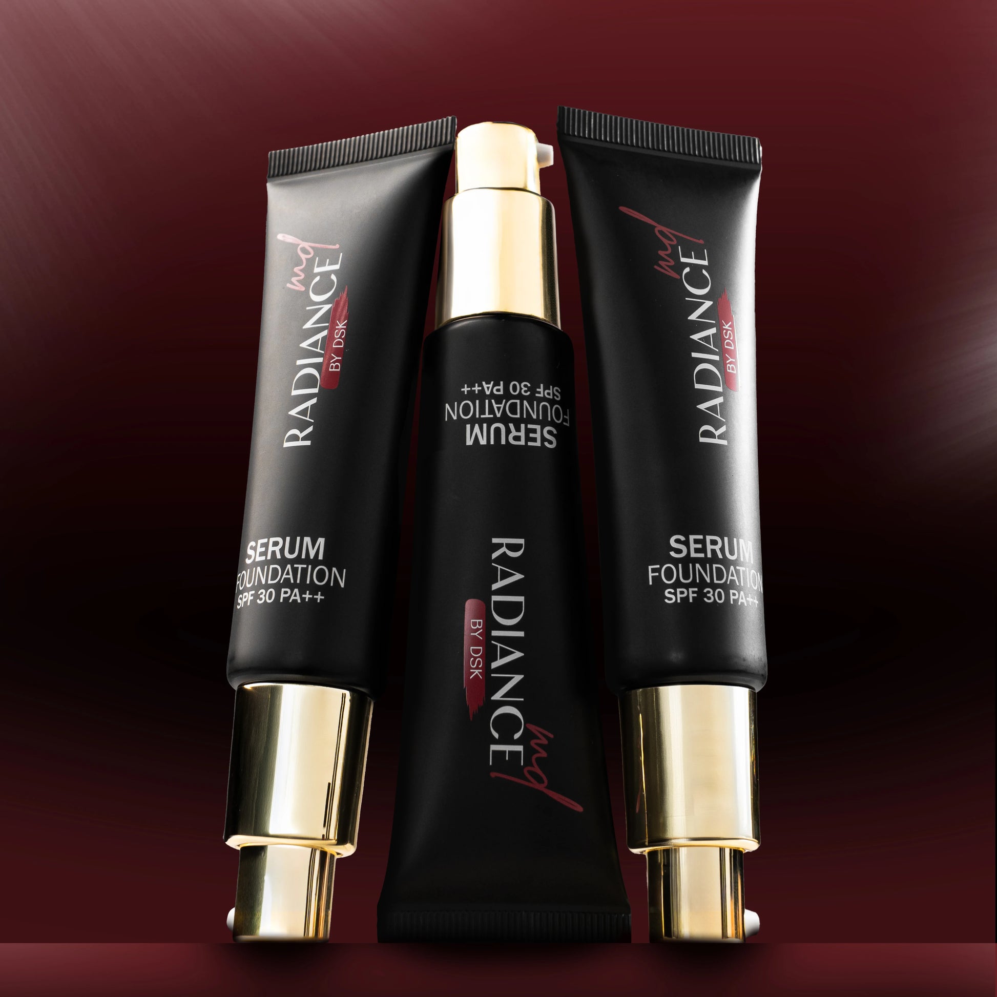 Radiance serum foundation tubes on a dark red background