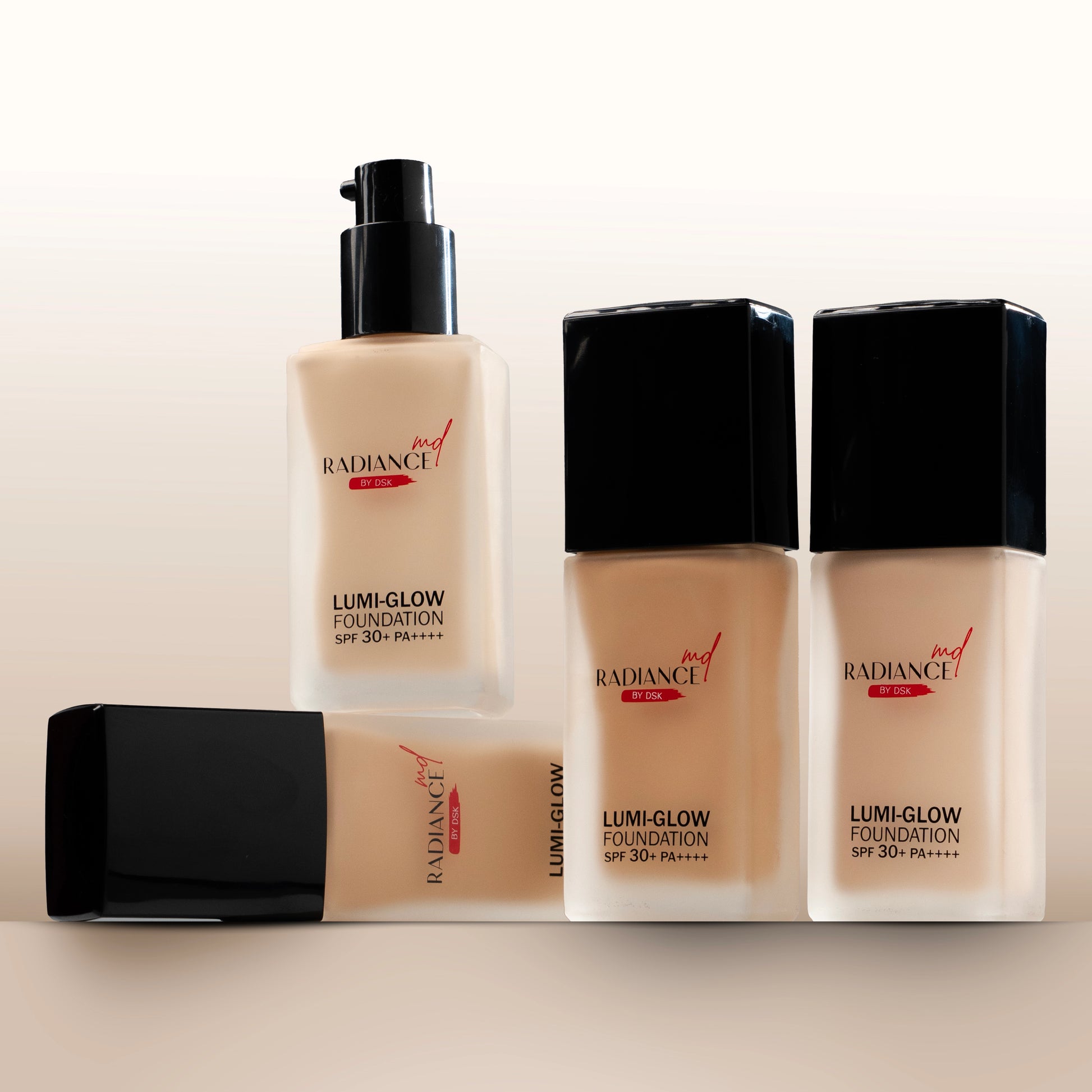 Lumi-Glow foundation bottles on a beige background